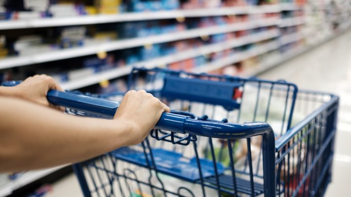 food recalls Closeup of shopper pushing a cart through a grocery aisle