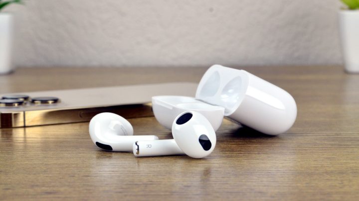 How to connect your AirPods Apple AirPods 3 on a table next to an iPhone 13 Pro