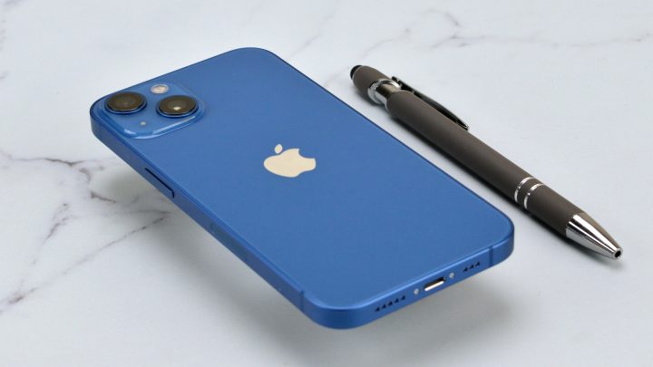 Blue Apple iPhone 14 on a marble table