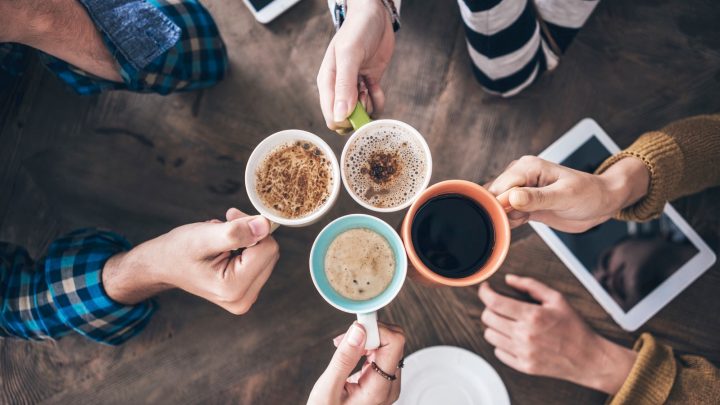 People drinking coffee from various types of cups.