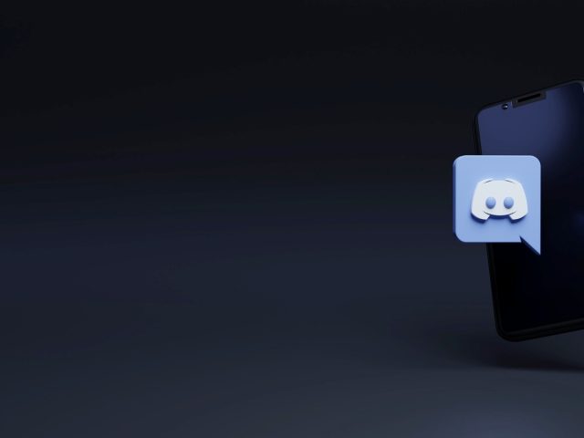 How to Report A User on Discord Discord logo on a smartphone.