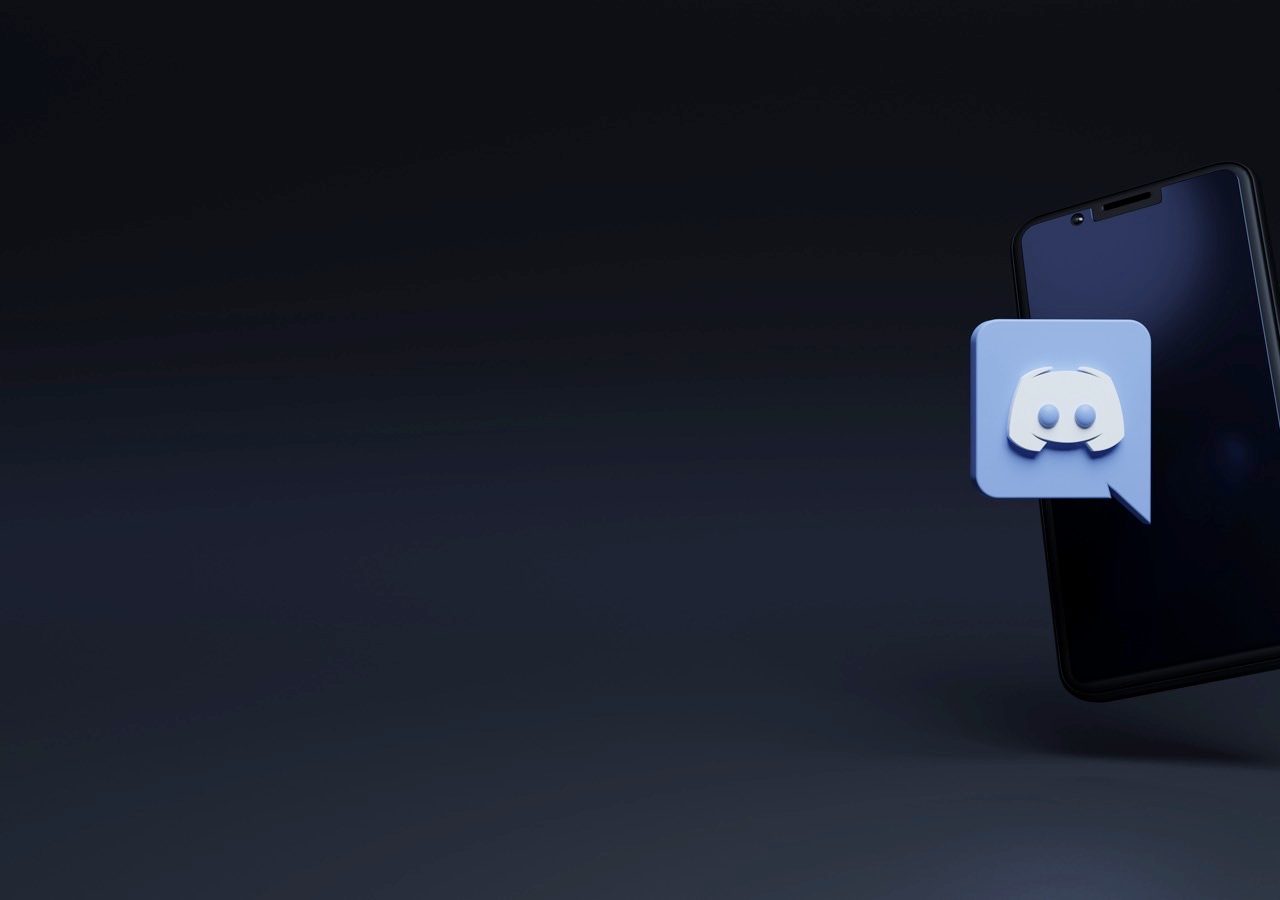 How to Report A User on Discord Discord logo on a smartphone.