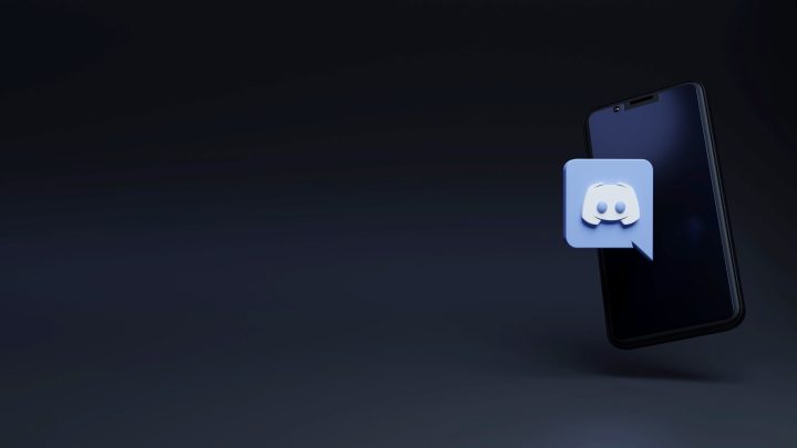 How to Report A User on Discord Discord logo on a smartphone.