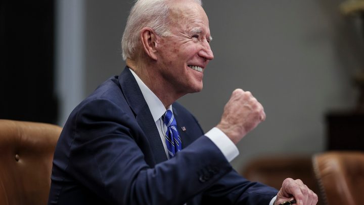 President Joe Biden waving to hecklers shouting Let's go Brandon!