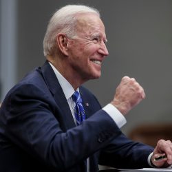 President Joe Biden waving to hecklers shouting Let's go Brandon!