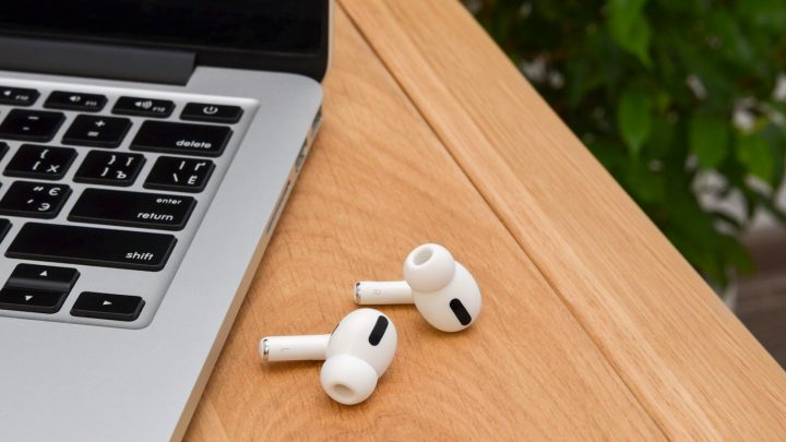 MacBook next to AirPods Pro.