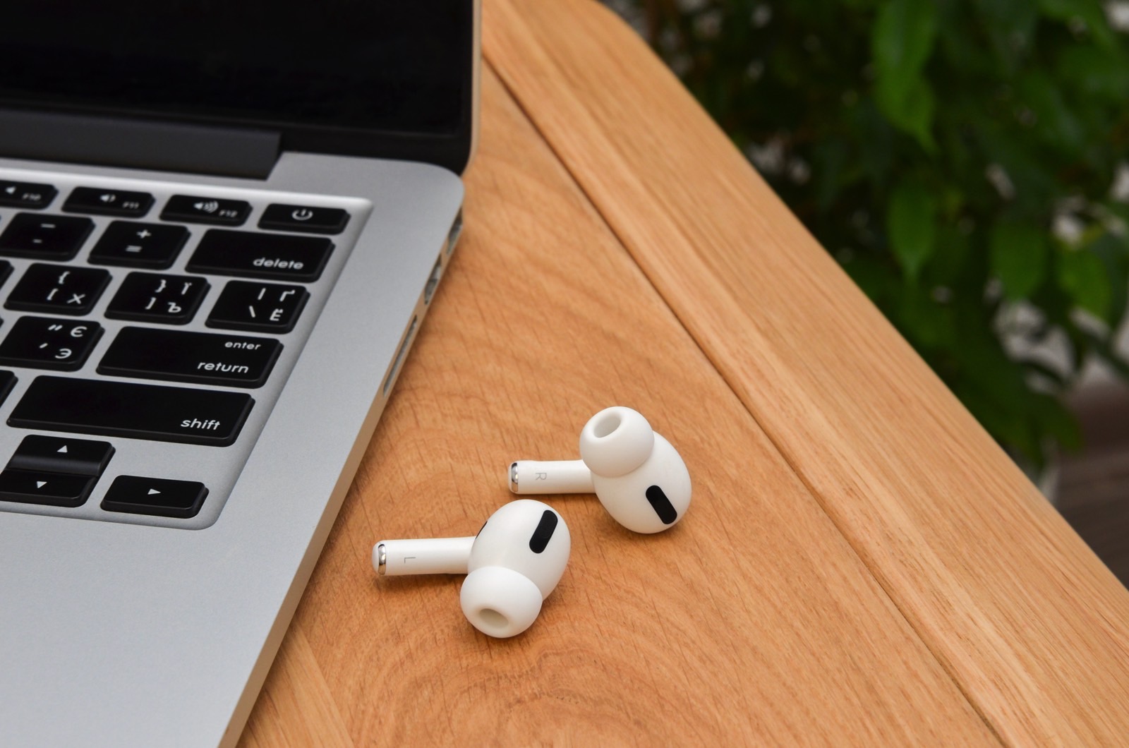 MacBook next to AirPods Pro.