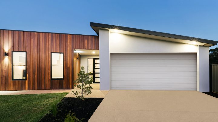 A modern house with a fancy garage door and impressive architecture