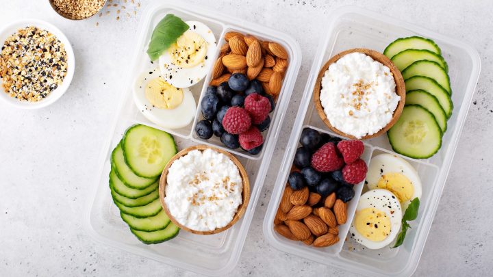 Lunch or snack box with high protein food, cottage cheese, nuts and eggs.