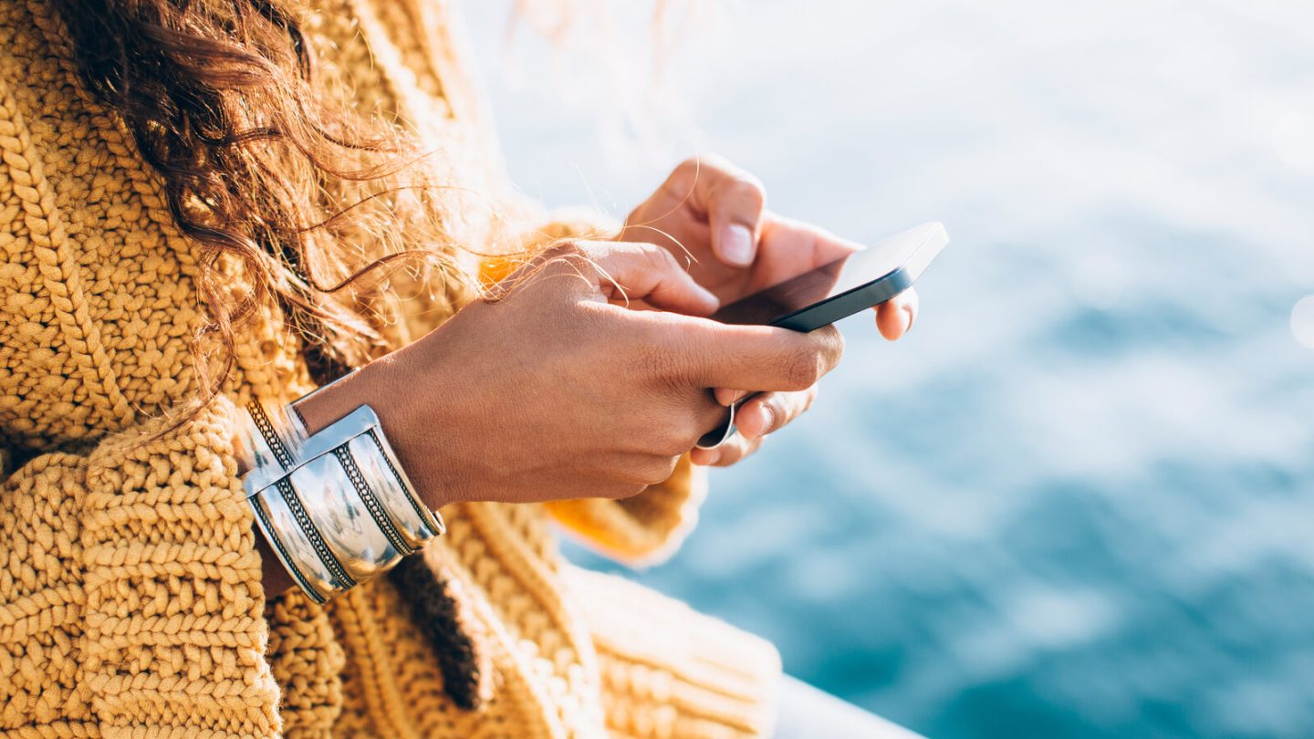 closeup of woman texting on iphone