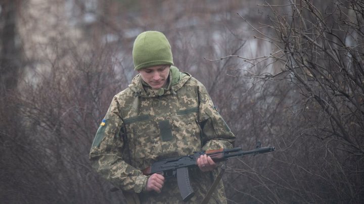 a ukranian solider holds a rifle