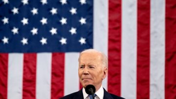 president biden in front of american flag