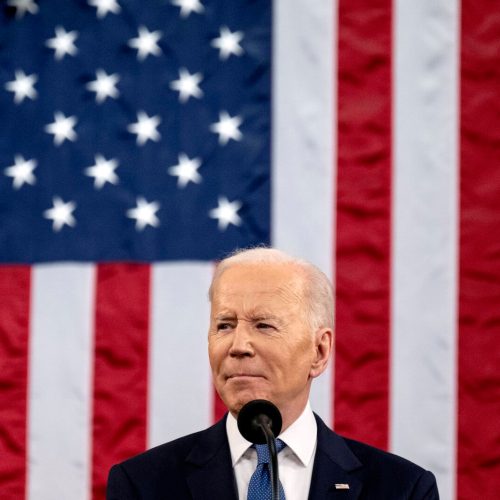 president biden in front of american flag