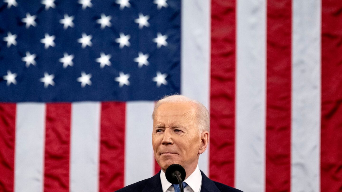 president biden in front of american flag