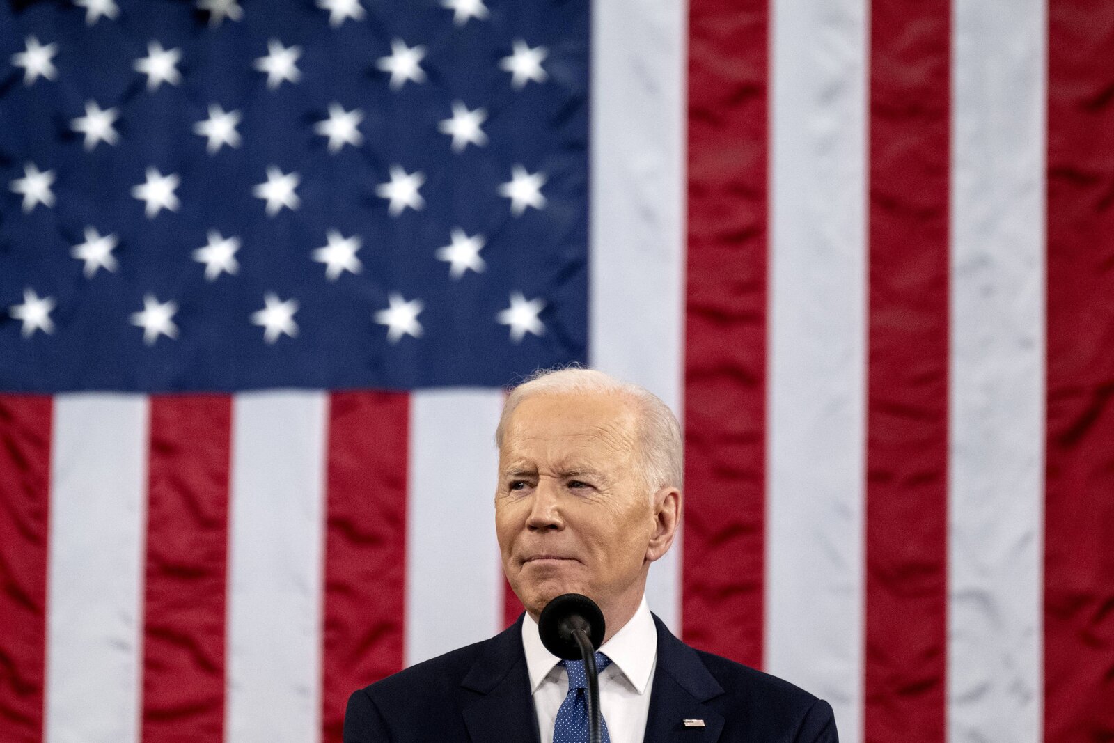 president biden in front of american flag