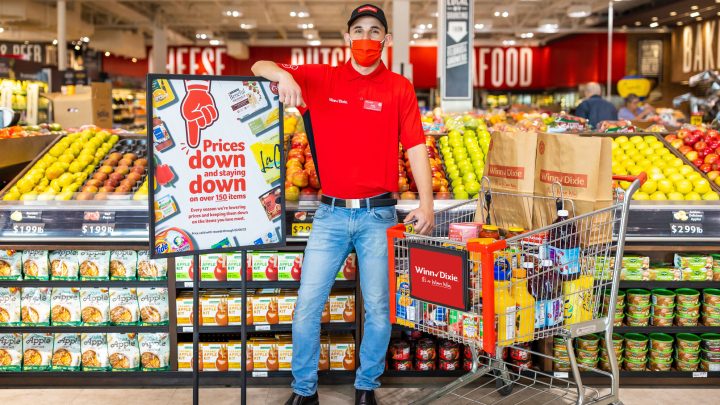 masked man stands in grocery store