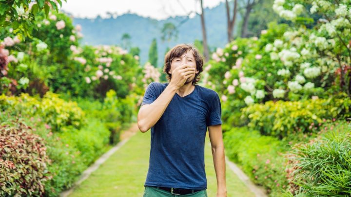 Young man suffering from seasonal allergies.