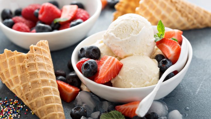 Vanilla ice cream scoops with fresh berries