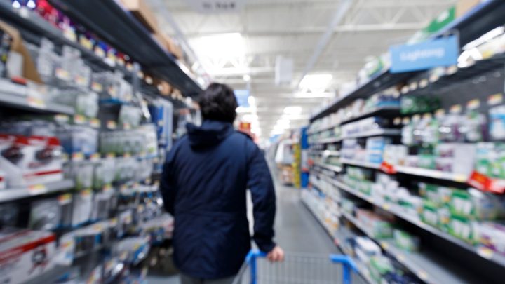 man in grocery store with shopping cart